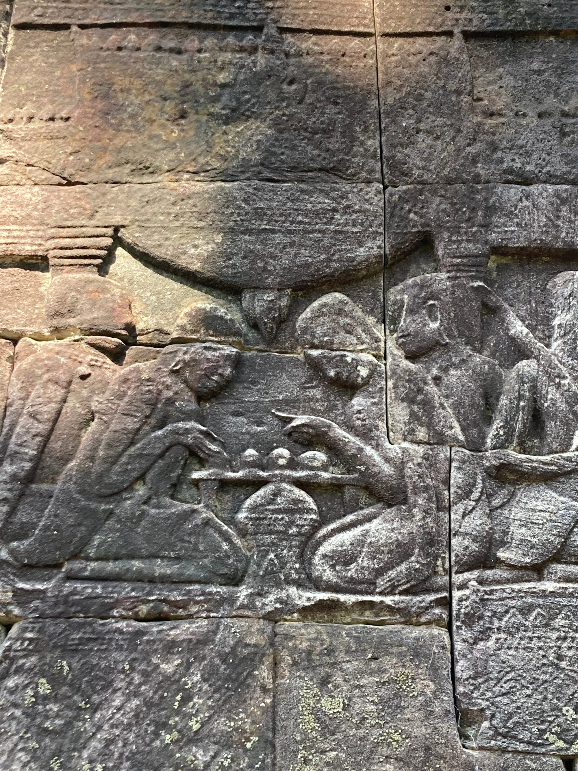 Bas relief carving from Bayon of two figures playing a board game