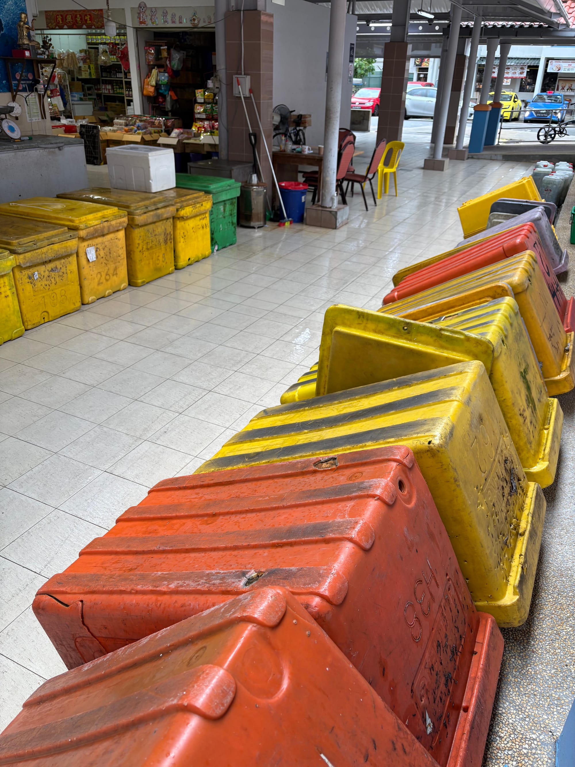 Rows of orange and yellow containers are lined up. 