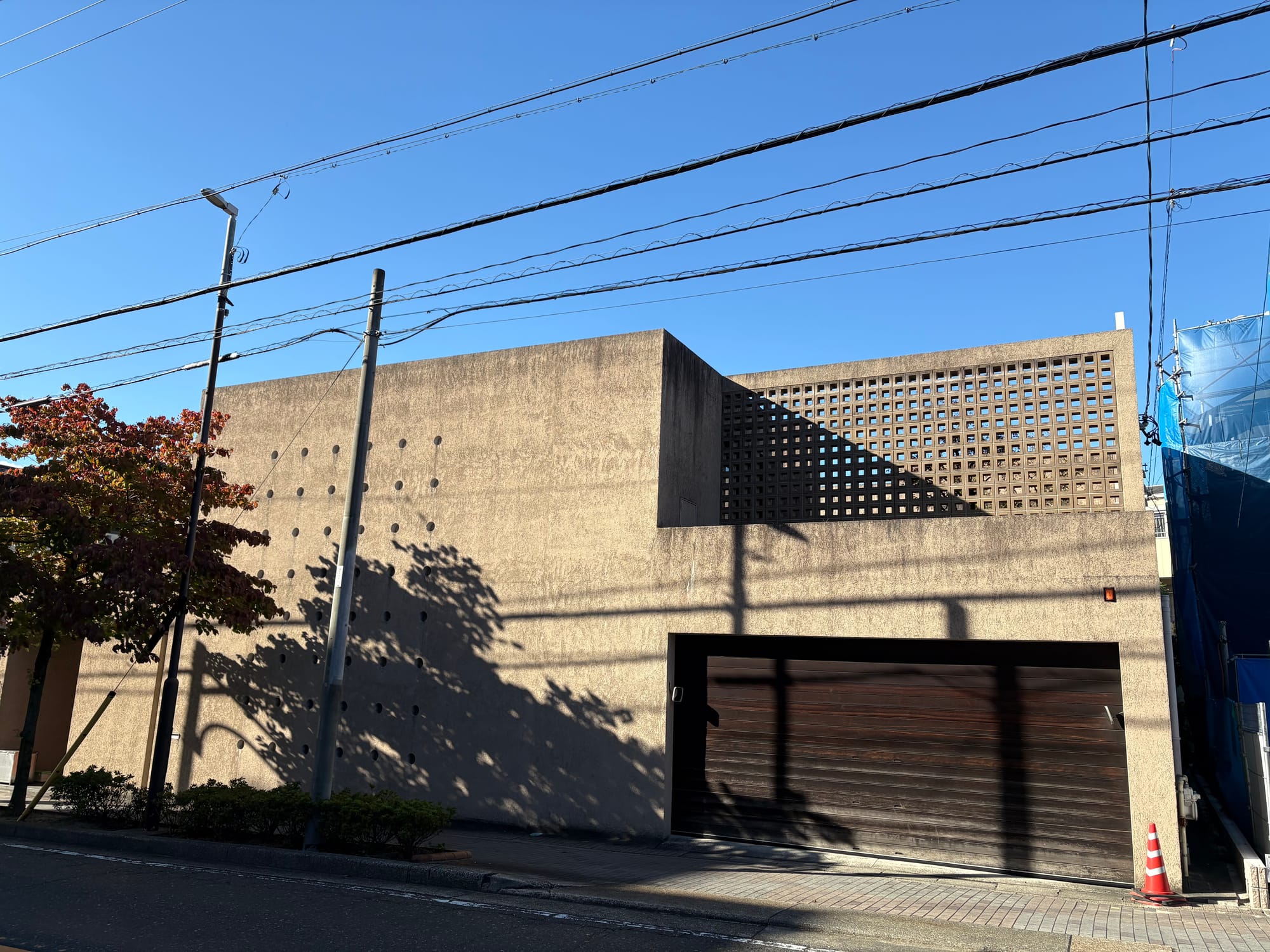 A boxy house in textured concrete with cutout holes and squares.